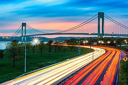 Verrazano Narrows Bridge above the light trails of the Belt Parkway traffic, at dusk. Credit: Mihai_Andritoiu / Shutterstock