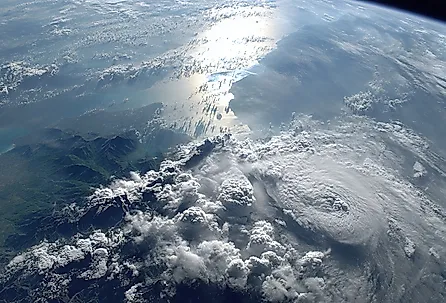A stunning view of Earth from space, showcasing the vastness of the ocean and the intricate patterns of clouds illuminated by the sun.