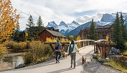 Residents walking the dogs in Town of Canmore in fall season. Image Credit Shawn.ccf via Shutterstock.