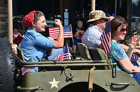 A parade participant recreating the iconic World War II image of Rosie the Riveter during a July 4th parade in Smyrna, Delaware. Editorial credit: The Old Major / Shutterstock.com