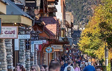 Crowds of people shopping on Banff Avenue in a autumn sunny day. Photo Credit: Shawn.ccf / Shutterstock.