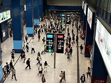 a bustling MTR (Mass Transit Railway) station in the Tai Wai area of Hong Kong. 
