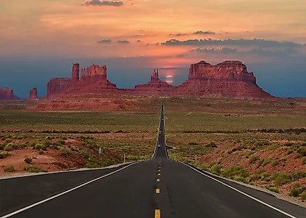 A highway running toward the buttes of Monument Valley near the Arizona-Utah line.
