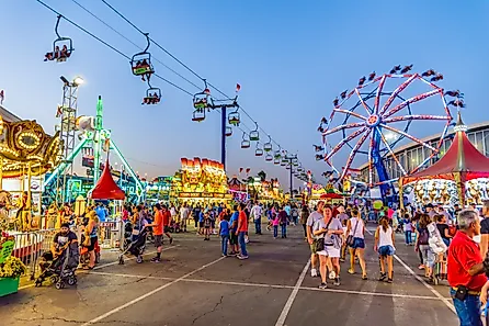 People stroll through the midway at the Arizona State Fair. By Gregory E. Clifford / Shutterstock.com