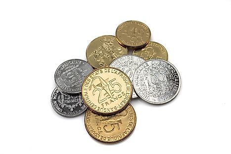 A collection of gold and silver West African Franc coins