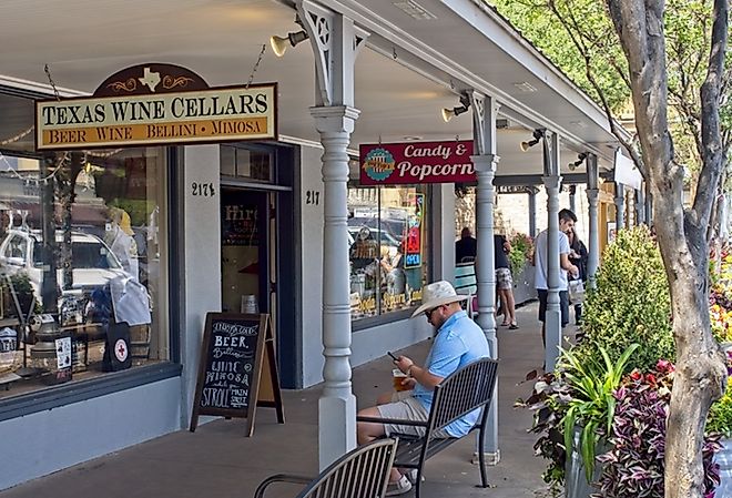 People walking around downtown Fredericksburg, Texas along the main street, via Peter Blottman Photography / iStock.com