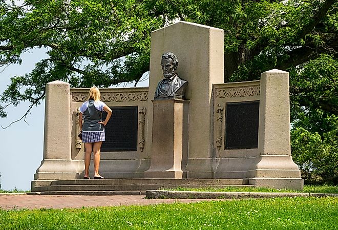 Woman looking at the Lincoln Address Memorial in Gettysburg, PA. Image credit Dennis MacDonald via Shutterstock.