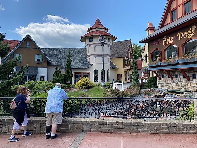 A couple of fellow tourists admiring the manicured naturescape and Bavarian architecture within Frankenmuth’s River Place Shops. Photo credit: Andrew Douglas