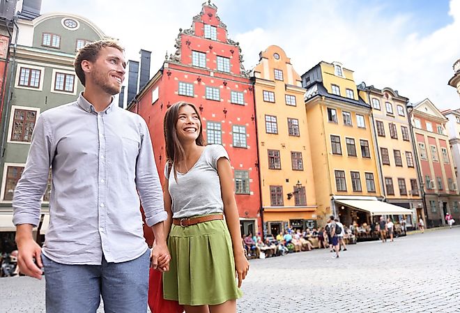 Smiling couple in Sweden's Stortorget Square in Gamla Stan.