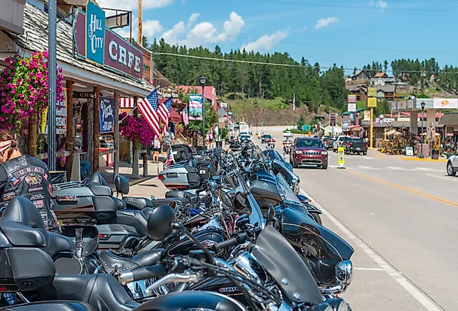 Bikes and Bikers gathering in Hill City for the 79th annual Sturgis Motorcycle Rally. Image credit mcrvlife via Shutterstock.