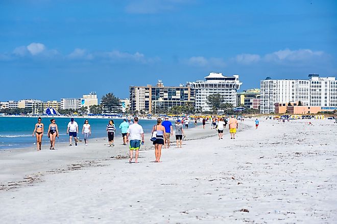 People enjoying in a beach in St. Pete Beach, Florida. Editorial credit: VIAVAL TOURS / Shutterstock.com