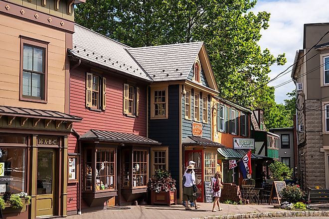 Visitors walking on sidewalk in front of storefronts in downtown Frenchtown, New Jersey, via aimintang on iStock.com