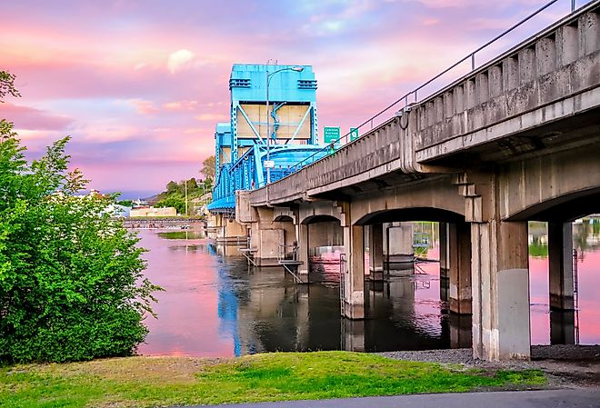 Historic Lewiston's Clarkston blue bridge against a pink sunset.