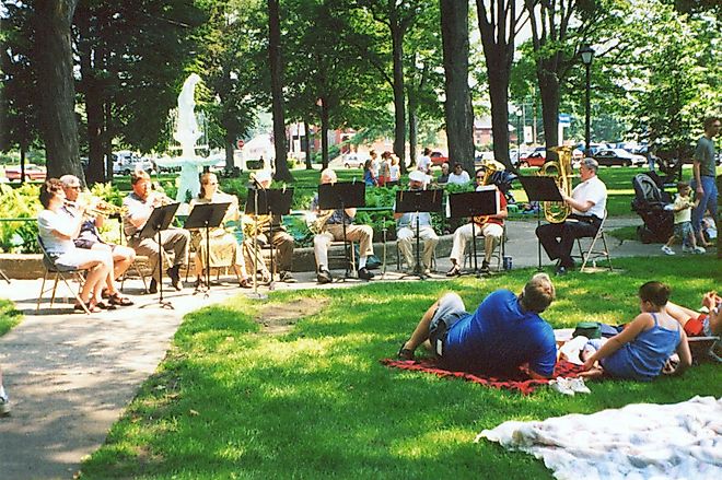 A band plays as picnickers listen in Gibson Park, Sackets Harbor, New York, via Wikimedia Commons - Public Domain