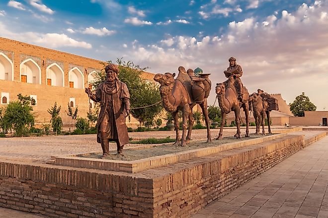 Sculpture group of an ancient caravan with camels carrying various goods along the Silk Road. 