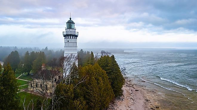 Aerial image of Cana Island Lighthouse in Wisconsin captured on a foggy day along Lake Michigan shoreline. Image by Photo Spirit via Shutterstock. 