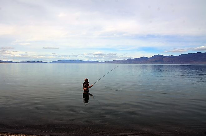 A fisherman fishing in Pyramid Lake which is a large natural lake and a world-class fishery in Nevada. Pyramid Lake, Nevada, United States Editorial credit: Daniel L. Locke / Shutterstock.com