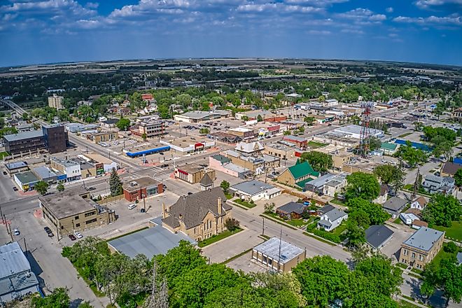 Aerial view of Portage la Prairie, Manitoba, showing the town's layout, green spaces, and surrounding farmland during summer