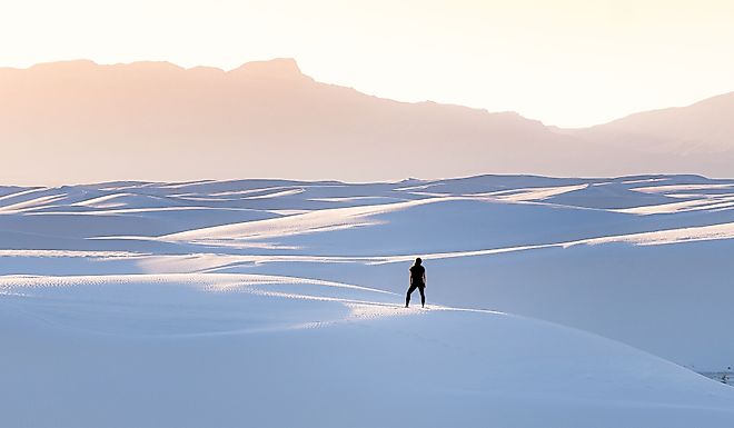 A female in black clothing admiring the view of mountains at White Sands National Park