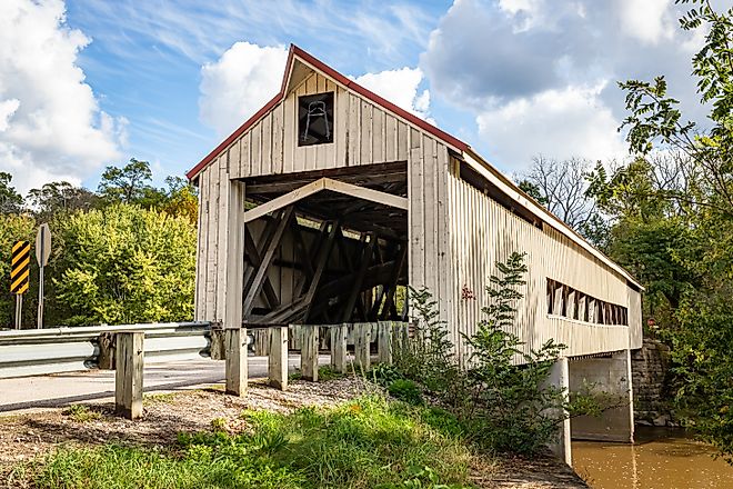 The Mechanicsville Covered Bridge crosses Grand River during the Autumn leaf color change in Ashtabula County, Ohio.