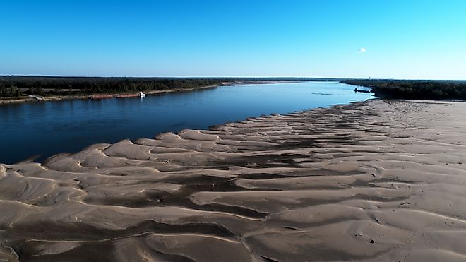 Aerial view from drone looking at low water on the Mississippi River. A line barge anchored on the left descending bank. Credit: Justin Wilkens/Shutterstock.com