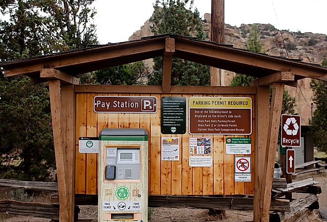 Pay station and information sign with a map of the park located at Welcome Center of Smith Rock State Park in Terrebonne, Oregon. Image credit bluestork via Shutterstock