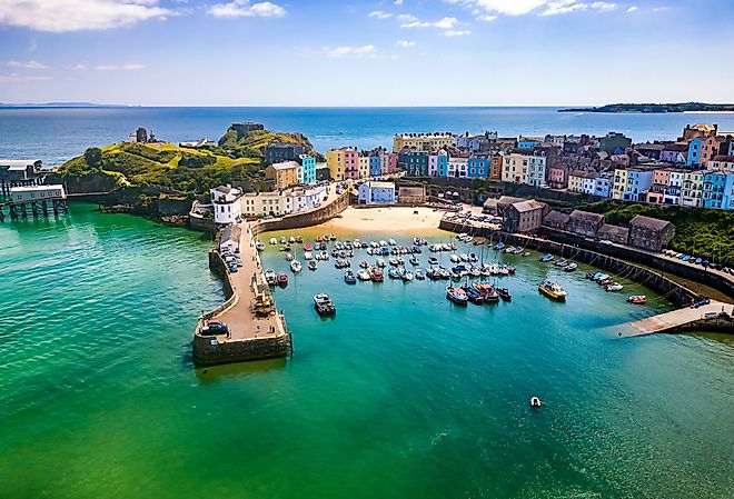 Aerial view of colorful buildings around a small harbor, in Tenby, Wales, UK.