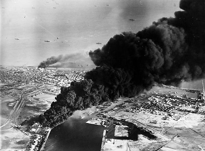 Smoke rises from oil tanks beside the Suez Canal hit during the initial Anglo-French assault on Port Said, 5 November 1956.