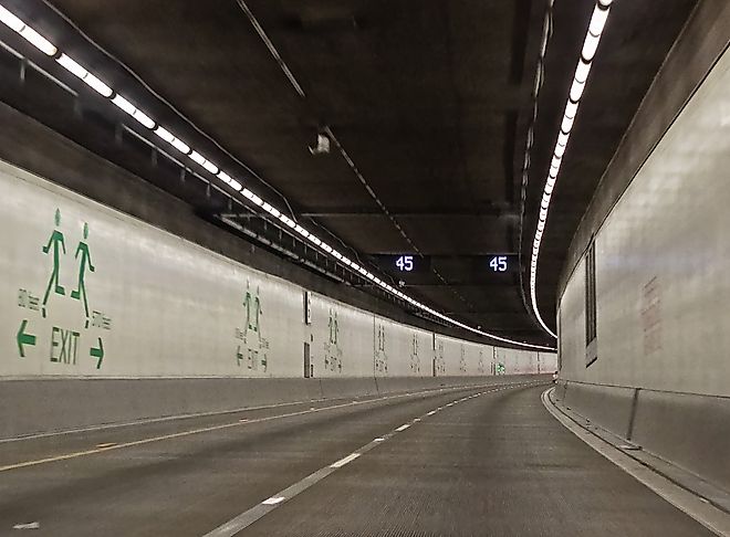Seattle SR 99 Tunnel Interior Roadway with Curving Lanes and Emergency Exit Signs