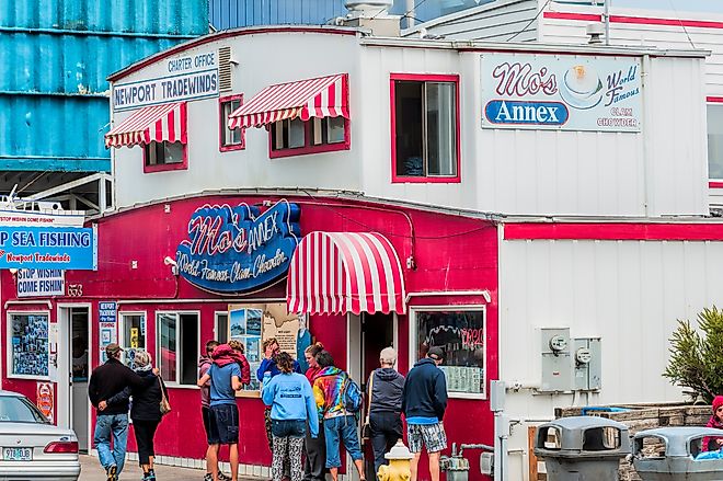 Dee Browning via Shutterstock. Newport, Oregon,USA: Tourist stand in front of Moe's seafood annex in downtown Newport.