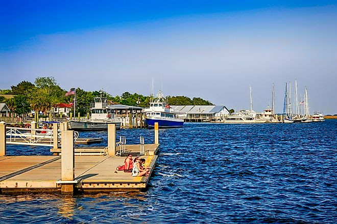 People on a landing dock for Cumberland Island at St. Mary's in Georgia, USA, via csfotoimages / iStock.com
