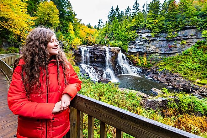 Young Woman on Boardwalk Overlook at Blackwater Falls State Park, West Virginia, USA, During Autumn.