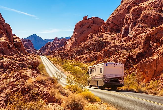 Motorhome trailer traveling on the road in Valley of Fire in Nevada. Image credit Nick Fox via Shutterstock.