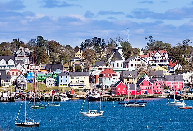 Lunenburg Harbour, Nova Scotia, with colorful red buildings and boats.