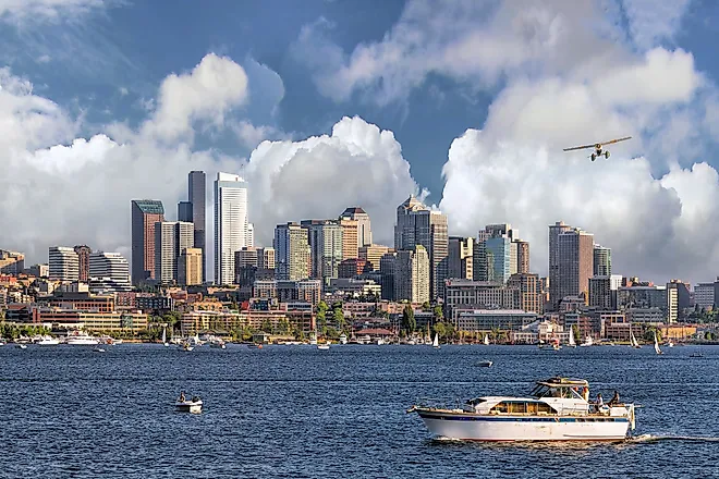 Seattle, Washington, city skyline from Lake Union with white clouds and blue sky. 