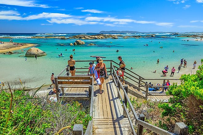 People swimming and canoeing on the sheltered waters of William Bay National Park in Denmark, Western Australia. Image credit: Benny Marty / Shutterstock.com.