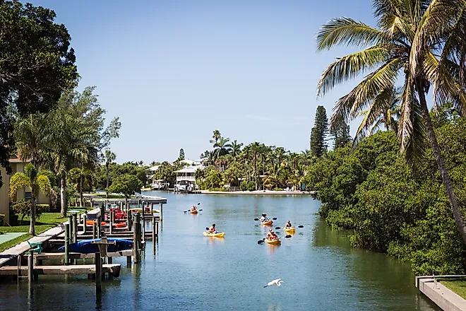  Kayakers floating in a canal on Anna Maria Island, Florida.