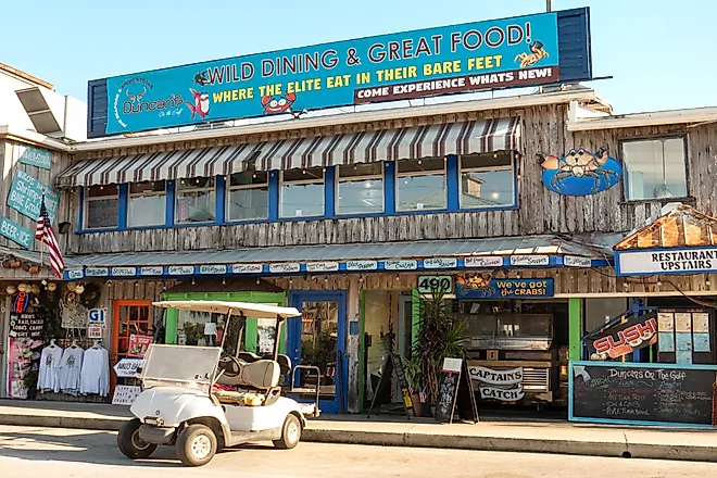 Shops and restaurants along the Gulf of Mexico waterfront in Cedar Key, Florida. Editorial credit: Leigh Trail / Shutterstock.com
