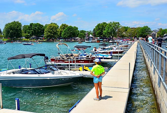 Pier and luxury boats docked in Skaneateles Lake, Skaneateles, New York. Image credit PQK via Shutterstock