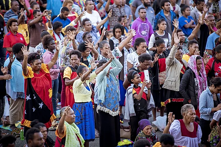 A group of people protesting on the streets of Papua, New Guinea. 