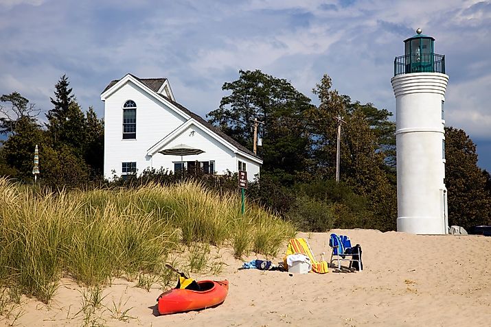Pictured here: a kayak, lighthouse and beach in Empire, Michigan.