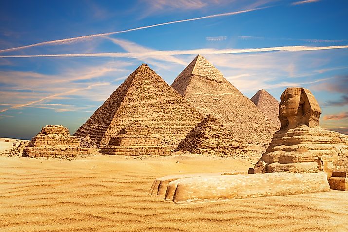 The Great Sphinx sits majestically by the Pyramids of Egypt in the Giza desert.