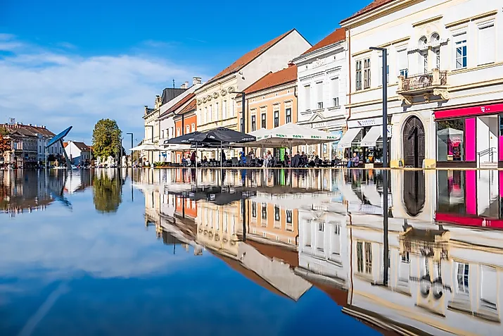 Scenic view of historic buildings and outdoor cafes reflected in a fountain under a bright blue sky in Koprivnica. (Editorial credit: Ivan Klindic / Shutterstock.com)