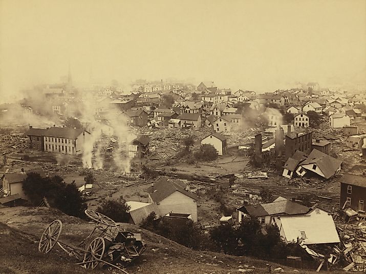 General view of Johnstown from high ground after the flood of May 31st, 1889. Horse drawn wagons and men work in the central mid-ground, possibly recovering bodies Editorial credit: Everett Collection / Shutterstock.com 