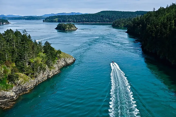 Boat in the ocean among islands. Deception Pass State Park near Anacortes WA.