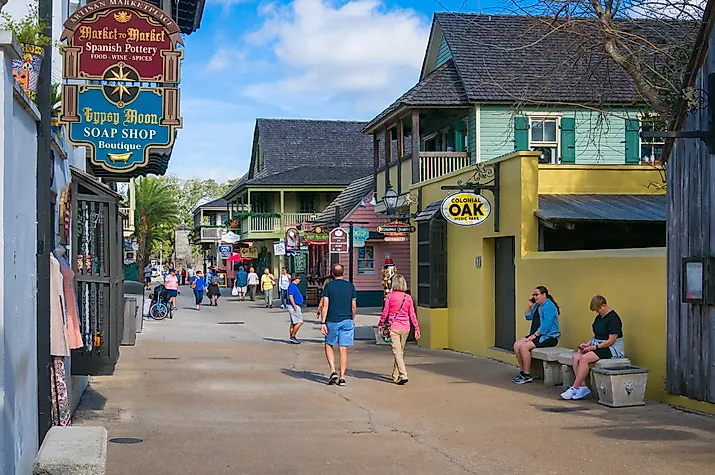 A few tourists walk along St. George street in St. Augustine, Florida, via KenWiedemann / iStock.com