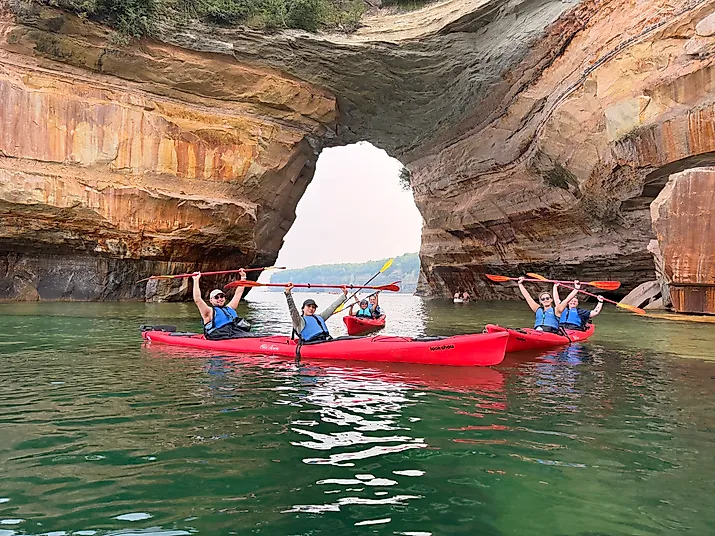 Pictured Rocks kayakers pose for a group photo in front of the famous Lover’s Leap sandstone arch. Image credit: Joshua Lutz