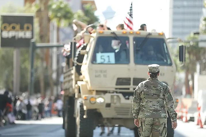 A female soldier of the US Army standing in front of a truck in the Veteran’s Day Parade. Editorial credit: RYO Alexandre / Shutterstock.com
