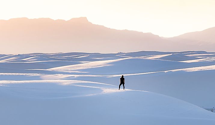 A female in black clothing admiring the view of mountains at White Sands National Park