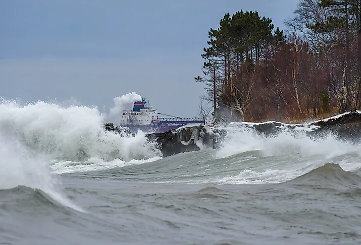 Lake Superior waves with a Great Lakes ore boat on the horizon.